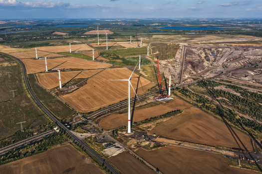 Aerial view of wind turbines installed near the Schleenhain lignite open cast mine with agricultural fields and infrastructure in Zwenkau Saxony Germany.