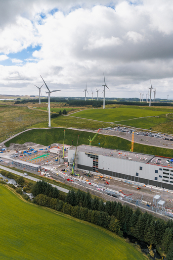 Aerial view of the Green Mountain data center construction site surrounded by wind turbines and green fields in Undheim Rogaland Norway. Aerial view of the Green Mountain data center construction site surrounded by wind turbines and green fields in Undheim Rogaland Norway.