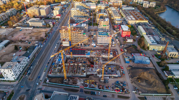 Aerial view of construction site at dawn cranes towering over the skeletal structures amidst a blend of urban development Prague 9 Prague Czechia. Aerial view of construction site at dawn cranes towering over the skeletal structures amidst a blend of urban development Prague 9 Prague Czechia.