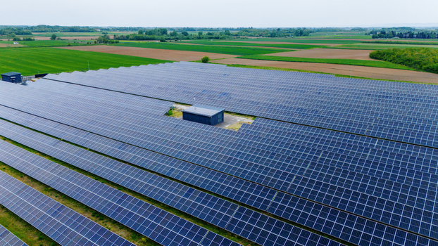 Aerial view of a large solar panel farm surrounded by green agricultural fields and rural landscape Sabac Vojvodina Serbia.