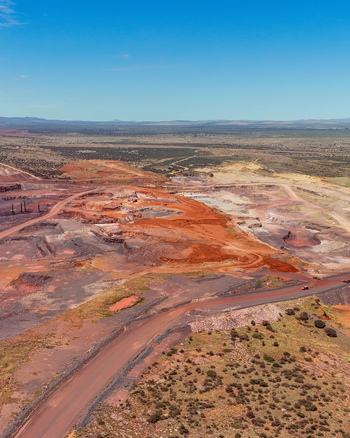 Aerial view of a large scale open pit mining operation featuring extensive red earth excavations haul roads and discarded tailings in the arid landscape of Thabazimbi Limpopo South Africa. Aerial view of a large scale open pit mining operation featuring extensive red earth excavations haul roads and discarded tailings in the arid landscape of Thabazimbi Limpopo South Africa.
