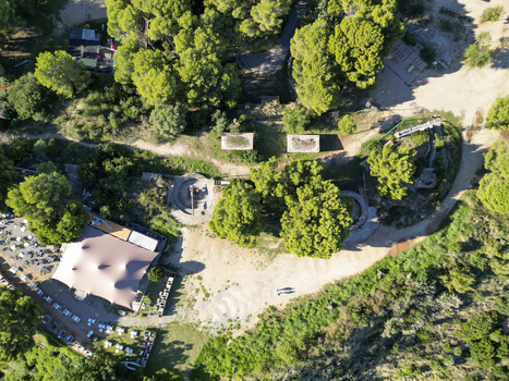 Aerial view of historic coastal fortifications and bunkers surrounded by pine trees and a restaurant terrace in Montgat Catalonia Spain. Aerial view of historic coastal fortifications and bunkers surrounded by pine trees and a restaurant terrace in Montgat Catalonia Spain.