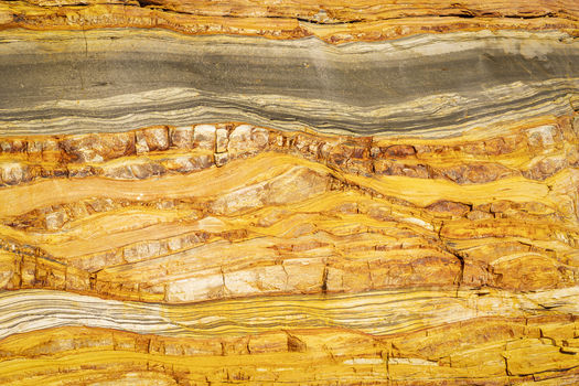 View of the geological rock formations and layered sediment at Silence Beach in Asturias Asturias Spain.