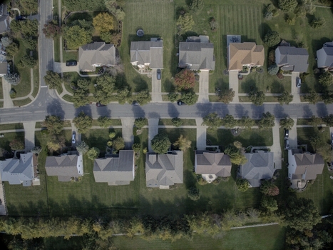 Aerial view of a suburban neighborhood with residential houses green lawns and tree lined streets in Mason Ohio United States.