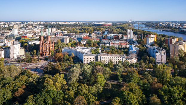 Aerial view of the towering St. Florian s Cathedral pierces the skyline amidst a tapestry of green trees and buildings Warsaw Poland. Aerial view of the towering St. Florian s Cathedral pierces the skyline amidst a tapestry of green trees and buildings Warsaw Poland.