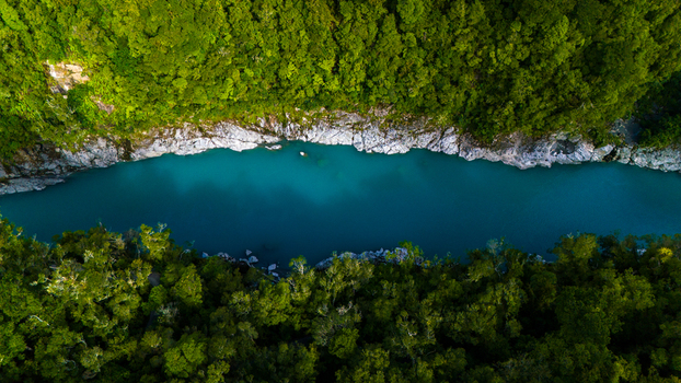 Aerial view of the Hokitika Gorge where turquoise waters carve through the rugged rock formations embraced by the verdant rainforest Hokitika Gorge Kokatahi New Zealand. Aerial view of the Hokitika Gorge where turquoise waters carve through the rugged rock formations embraced by the verdant rainforest Hokitika Gorge Kokatahi New Zealand.