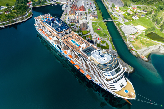 Flam Vestland Norway 18 June 2026 Aerial view of a large cruise ship docked at the port of Flam surrounded by lush green mountains and the deep blue waters of the Aurlandsfjord. Flam Vestland Norway 18 June 2026 Aerial view of a large cruise ship docked at the port of Flam surrounded by lush green mountains and the deep blue waters of the Aurlandsfjord.