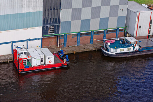 Wormer Netherlands 10 April 2026 Aerial view of a vibrant red electric pusher tug juxtaposed against the industrial backdrop of the Olam International cocoa factory. Wormer Netherlands 10 April 2026 Aerial view of a vibrant red electric pusher tug juxtaposed against the industrial backdrop of the Olam International cocoa factory.