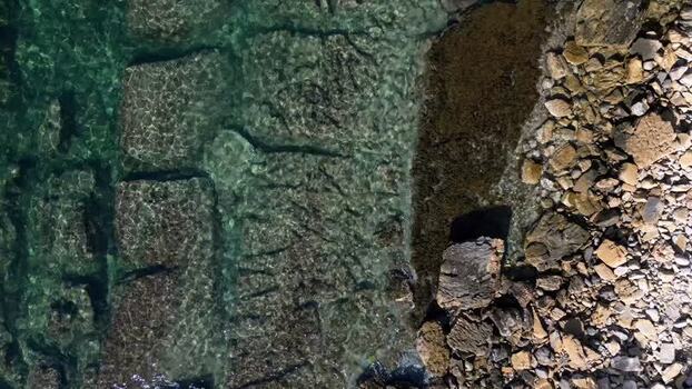 Aerial view of rocky coastline and clear water in Moraira Spain.
