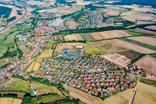 Aerial view of the town of Schlusselfeld with its red roofed houses industrial areas and surrounding agricultural fields Schlusselfeld Bavaria Germany. Aerial view of the town of Schlusselfeld with its red roofed houses industrial areas and surrounding agricultural fields Schlusselfeld Bavaria Germany.