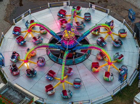 Aerial view of a colorful octopus themed amusement park ride with spinning cars and people enjoying the motion in Vilnius Vilnius County Lithuania. Aerial view of a colorful octopus themed amusement park ride with spinning cars and people enjoying the motion in Vilnius Vilnius County Lithuania.