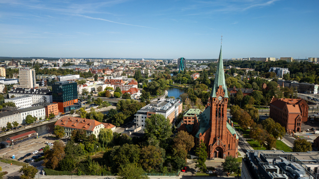 Aerial view of the towering spire of the Church piercing the skyline amidst Bydgoszcz s architectural tapestry and verdant parks Bydgoszcz Województwo kujawsko pomorskie Poland. Aerial view of the towering spire of the Church piercing the skyline amidst Bydgoszcz s architectural tapestry and verdant parks Bydgoszcz Województwo kujawsko pomorskie Poland.