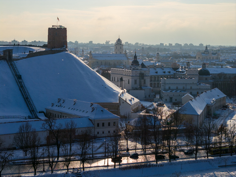 Aerial view of Gediminas Tower on a snow covered hill and the Palace of the Grand Dukes under a winter sky in Vilnius County Lithuania.