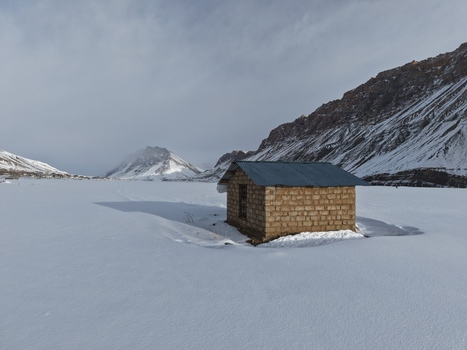 Kaza India 28 January 2026 View of a small stone hut with a corrugated metal roof standing in a vast snow covered landscape of Spiti Valley surrounded by rugged mountains. Kaza India 28 January 2026 View of a small stone hut with a corrugated metal roof standing in a vast snow covered landscape of Spiti Valley surrounded by rugged mountains.