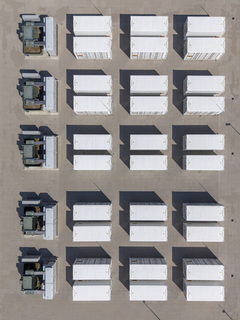 Aerial view of the Battery Energy Storage System at Wind Park featuring rows of white shipping containers and electrical equipment on a paved surface in Dronten Flevoland Netherlands. Aerial view of the Battery Energy Storage System at Wind Park featuring rows of white shipping containers and electrical equipment on a paved surface in Dronten Flevoland Netherlands.