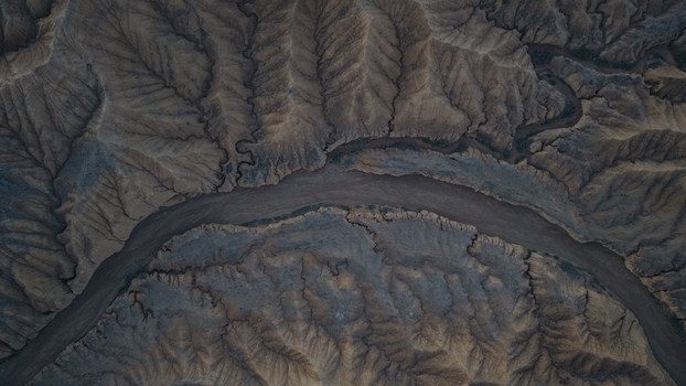 Aerial view of the rugged eroded landscape and canyon formations near Issyk Kul in the Issyk Kul Region Kyrgyzstan. Aerial view of the rugged eroded landscape and canyon formations near Issyk Kul in the Issyk Kul Region Kyrgyzstan.