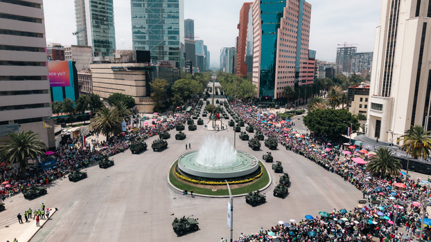 Aerial view of a military parade with armored vehicles and soldiers moving along Paseo de la Reforma past the Diana Cazadora fountain in Mexico City Mexico City Mexico.