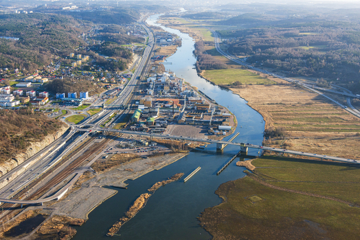 Aerial view of the Bohus area featuring the river highway bridge industrial buildings and surrounding landscape in Ale Vastra Gotaland County Sweden. Aerial view of the Bohus area featuring the river highway bridge industrial buildings and surrounding landscape in Ale Vastra Gotaland County Sweden.