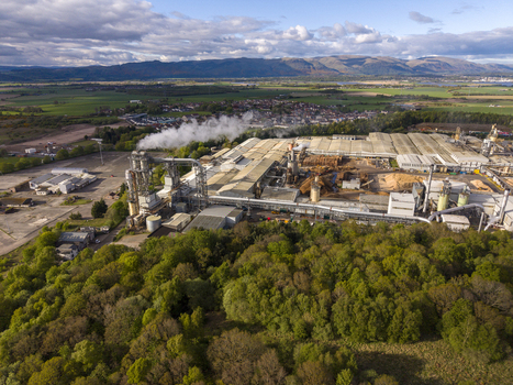 Cowie United Kingdom 06 May 2026 Aerial view of an industrial manufacturing plant with smoking chimneys surrounded by lush green forests and rolling hills under a cloudy sky. Cowie United Kingdom 06 May 2026 Aerial view of an industrial manufacturing plant with smoking chimneys surrounded by lush green forests and rolling hills under a cloudy sky.