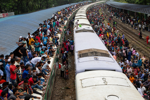 Dhaka Bangladesh 15 June 2018 View of Airport Railway Station crowded with people sitting on train roofs and platforms during Eid al Fitr travel rush. Dhaka Bangladesh 15 June 2018 View of Airport Railway Station crowded with people sitting on train roofs and platforms during Eid al Fitr travel rush.