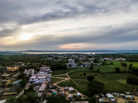 Aerial view of a tranquil landscape where the setting sun casts a warm glow over the horizon painting the sky with soft hues Chakswari Azad Kashmir Pakistan. Aerial view of a tranquil landscape where the setting sun casts a warm glow over the horizon painting the sky with soft hues Chakswari Azad Kashmir Pakistan.