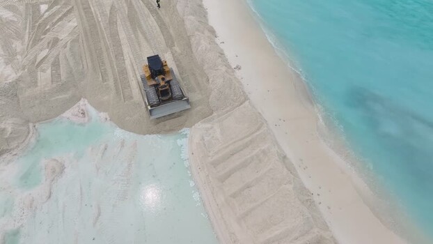 Aerial view of a bulldozer working on land reclamation Maldives. Aerial view of a bulldozer working on land reclamation Maldives.