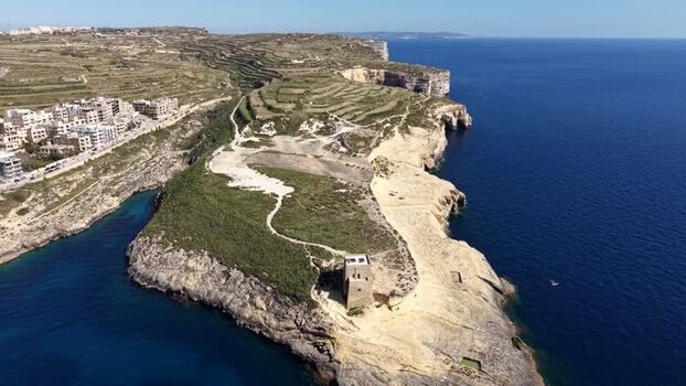 Aerial view of Xlendi Tower on the rocky cliffs of Gozo Malta. Aerial view of Xlendi Tower on the rocky cliffs of Gozo Malta.