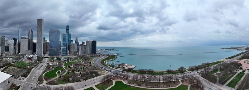 Aerial view of modern skyscrapers Millennium Park and Lake Michigan along the waterfront in Chicago. Aerial view of modern skyscrapers Millennium Park and Lake Michigan along the waterfront in Chicago.