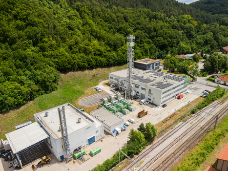 Aerial view of the STEFE Banska Bystrica heating plant featuring industrial buildings solar panels and a tall chimney near railway tracks in Banska Bystrica Banskobystricky kraj Slovakia. Aerial view of the STEFE Banska Bystrica heating plant featuring industrial buildings solar panels and a tall chimney near railway tracks in Banska Bystrica Banskobystricky kraj Slovakia.