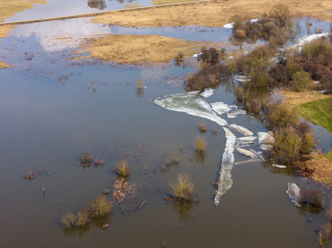 Aerial view of flooded fields with melting ice floes and bare trees during the spring thaw in Kedainiai Kaunas County Lithuania. Aerial view of flooded fields with melting ice floes and bare trees during the spring thaw in Kedainiai Kaunas County Lithuania.