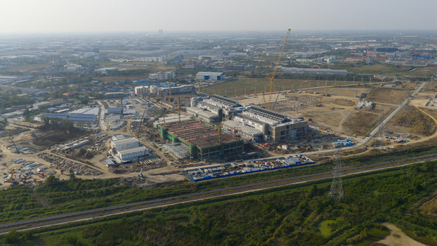 Aerial view of Bridge Data Center under construction with cranes and industrial structures under a clear sky in Khlong Tamru Chon Buri Thailand. Aerial view of Bridge Data Center under construction with cranes and industrial structures under a clear sky in Khlong Tamru Chon Buri Thailand.