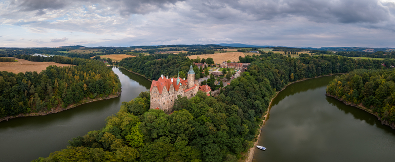 Aerial view of Czocha Castle surrounded by dense forests and the Kwisa River under a cloudy sky in Sucha Dolnoslaskie Poland. Aerial view of Czocha Castle surrounded by dense forests and the Kwisa River under a cloudy sky in Sucha Dolnoslaskie Poland.