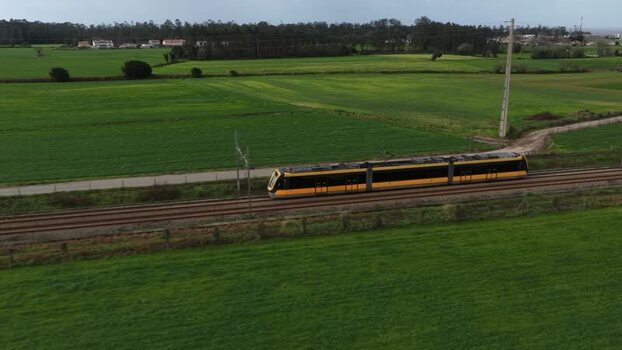 Aerial view of train crossing fields Portugal.