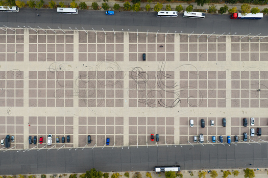 Aerial view of the paved parking area at Olympiastadion Berlin featuring tire marks from drifting parked cars and buses in Berlin Berlin Germany.