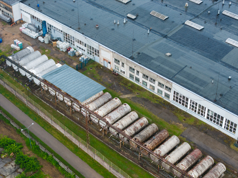Olaine parish Latvia 04 July 2026 Aerial view of industrial storage tanks lined up at a facility with a large warehouse building. Olaine parish Latvia 04 July 2026 Aerial view of industrial storage tanks lined up at a facility with a large warehouse building.