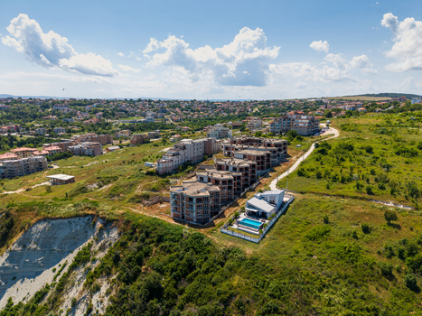 Aerial view of modern residential buildings under construction and a villa with a swimming pool on the coastal cliff in Byala Varna Bulgaria. Aerial view of modern residential buildings under construction and a villa with a swimming pool on the coastal cliff in Byala Varna Bulgaria.