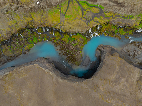 Aerial view of Sigoldugljufur canyon featuring turquoise river water cascading waterfalls and vibrant green moss on rocky cliffs in Rangarthing ytra Iceland. Aerial view of Sigoldugljufur canyon featuring turquoise river water cascading waterfalls and vibrant green moss on rocky cliffs in Rangarthing ytra Iceland.