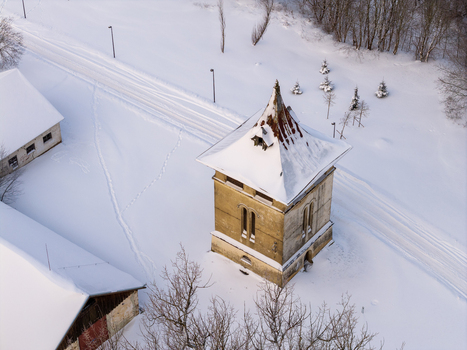 Aerial view of the historic tower at Traku Voke Manor surrounded by a thick layer of white snow and bare trees in winter Vilnius Vilniaus apskritis Lithuania.