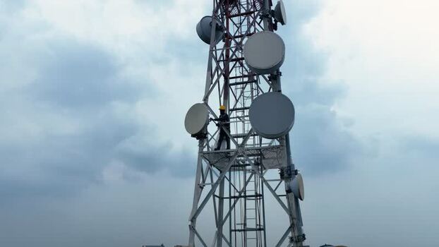 Aerial view of a technician working on a telecom tower Bangladesh.