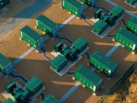 Aerial view of Battery Energy park BESS Grendon featuring rows of green energy storage containers and electrical infrastructure on a gravel site in Northampton England United Kingdom. Aerial view of Battery Energy park BESS Grendon featuring rows of green energy storage containers and electrical infrastructure on a gravel site in Northampton England United Kingdom.