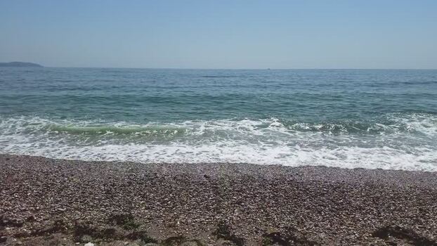 View of the pebble beach and calm sea in Charlestown United Kingdom. View of the pebble beach and calm sea in Charlestown United Kingdom.