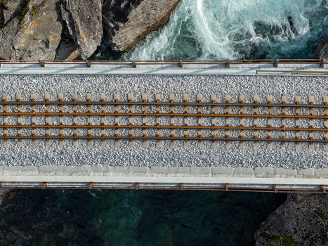 Aerial view of a railway bridge crossing a river with rocky banks in Bjorli Innlandet Norway. Aerial view of a railway bridge crossing a river with rocky banks in Bjorli Innlandet Norway.