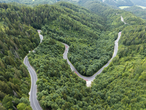 Aerial view of the winding road through the dense forest of Vernarske Chvalabohu in Vernar Presovsky kraj Slovakia. Aerial view of the winding road through the dense forest of Vernarske Chvalabohu in Vernar Presovsky kraj Slovakia.