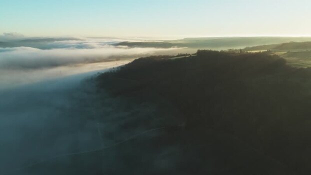 Aerial view of fields shrouded in fog France.