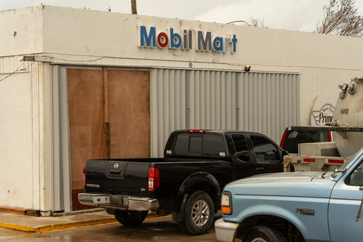 San Jose Tinian Northern Mariana Islands 05 July 2026 View of a boarded up Mobil Mart store with a black pickup truck parked in front in the aftermath of a storm. San Jose Tinian Northern Mariana Islands 05 July 2026 View of a boarded up Mobil Mart store with a black pickup truck parked in front in the aftermath of a storm.