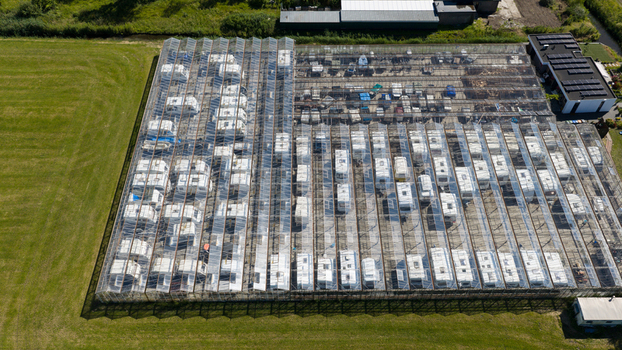 Aerial view of Caravanstalling Klijn a large glass roofed storage facility filled with numerous caravans surrounded by lush green fields in Alkmaar Noord Holland Netherlands. Aerial view of Caravanstalling Klijn a large glass roofed storage facility filled with numerous caravans surrounded by lush green fields in Alkmaar Noord Holland Netherlands.