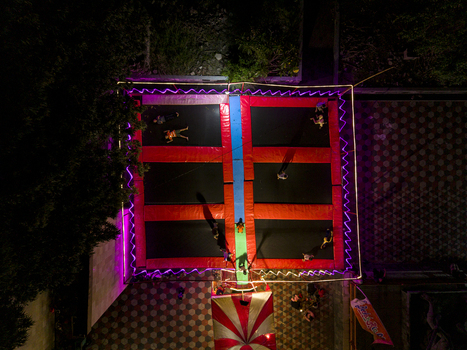 Aerial view of the trampoline park at GOR Gelarsena Klaten Night Market with neon lights and people jumping at night Kecamatan Klaten Utara Jawa Tengah Indonesia. Aerial view of the trampoline park at GOR Gelarsena Klaten Night Market with neon lights and people jumping at night Kecamatan Klaten Utara Jawa Tengah Indonesia.