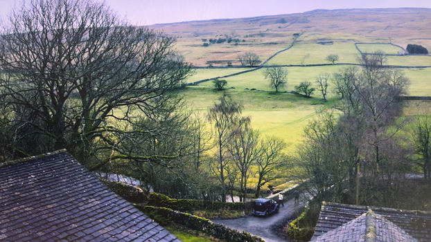 View of the rolling green hills and stone walls of the Yorkshire Dales with a vintage car and people walking on a narrow road Hawes England United Kingdom. View of the rolling green hills and stone walls of the Yorkshire Dales with a vintage car and people walking on a narrow road Hawes England United Kingdom.
