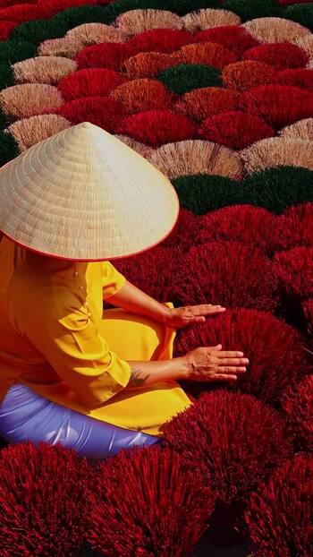 View of a person among colorful incense bundles Vietnam.