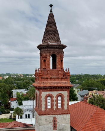Aerial view of the ornate red brick tower of Grace United Methodist Church rising above the historic residential rooftops in St. Augustine Florida United States. Aerial view of the ornate red brick tower of Grace United Methodist Church rising above the historic residential rooftops in St. Augustine Florida United States.